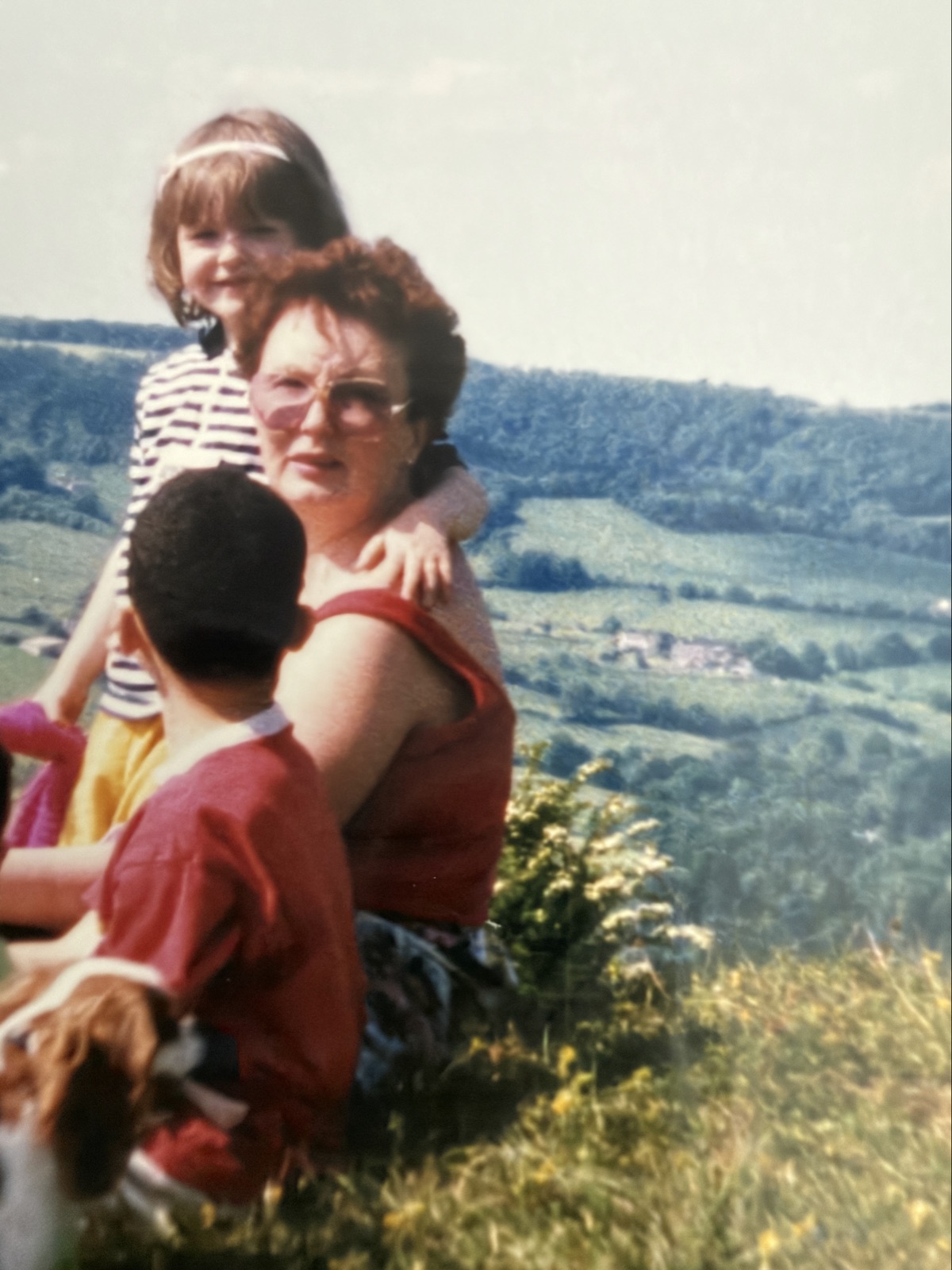 Ava carrying young Melissa in the countryside